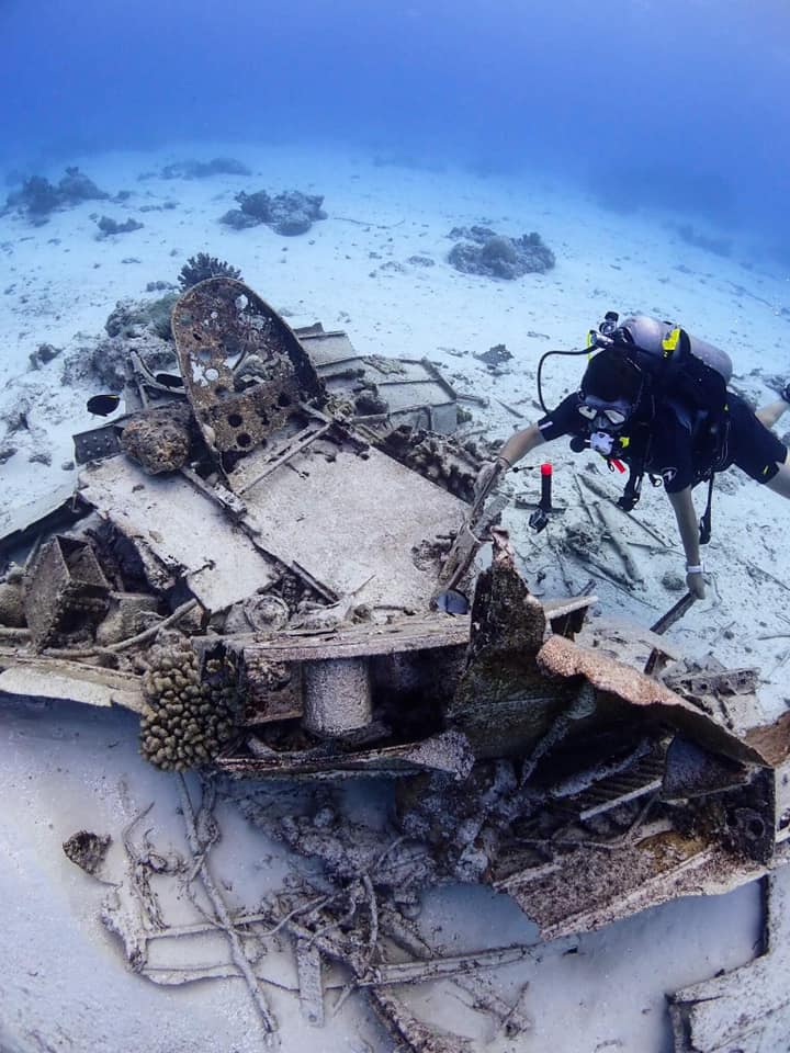 Miranda diving next to wreckage